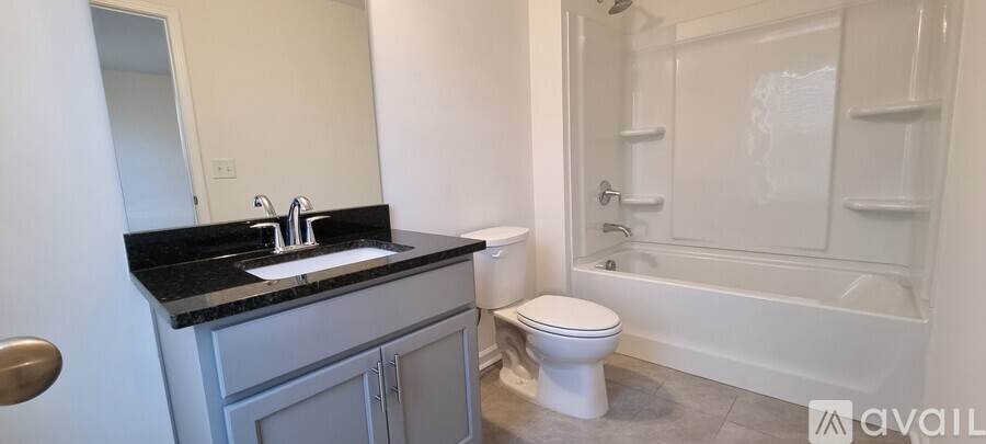 A bathroom with a sink, toilet and bathtub.