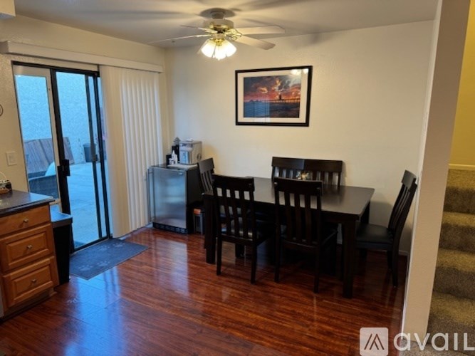 A dining room with a wooden table and chairs.