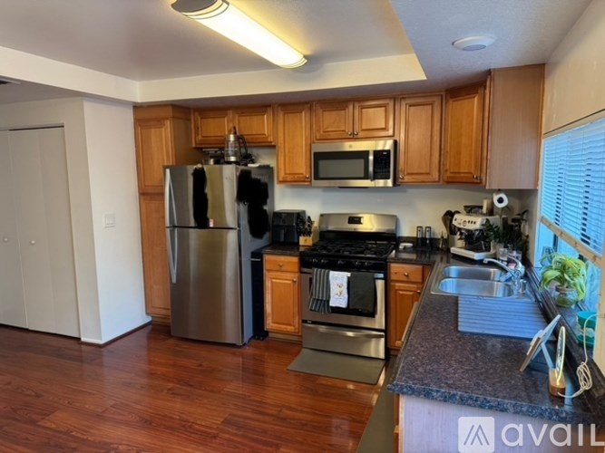 A kitchen with wooden cabinets and stainless steel appliances.