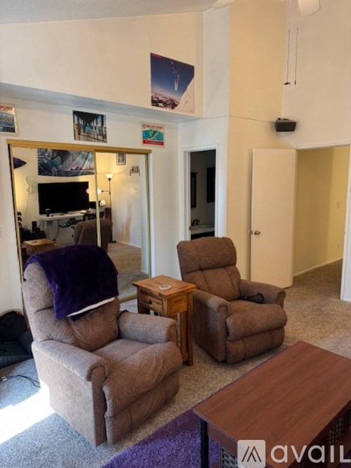 A living room with a brown recliner and a brown table.