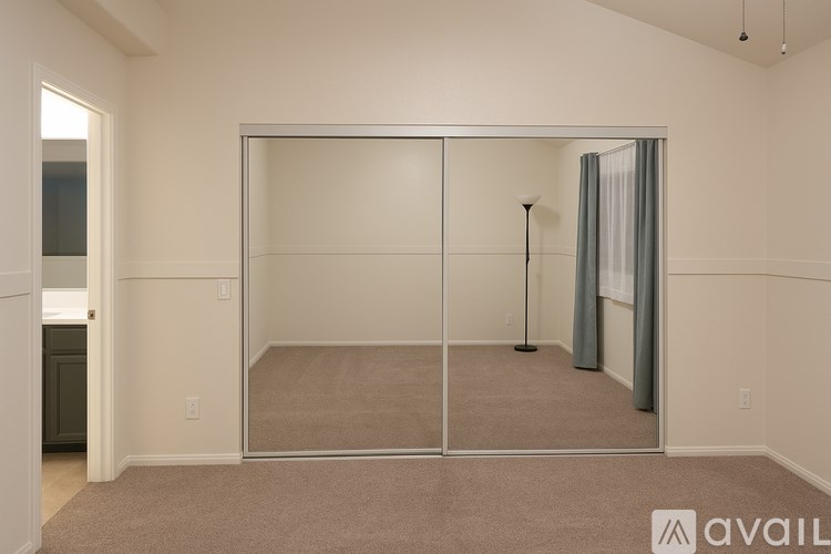 A room with a carpeted floor and a sliding glass door.