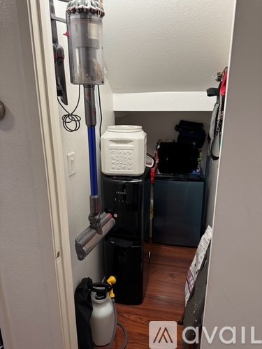 A small room with a water filtration system and a white container.
