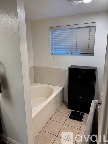 A bathroom with a bathtub, toilet, and sink.