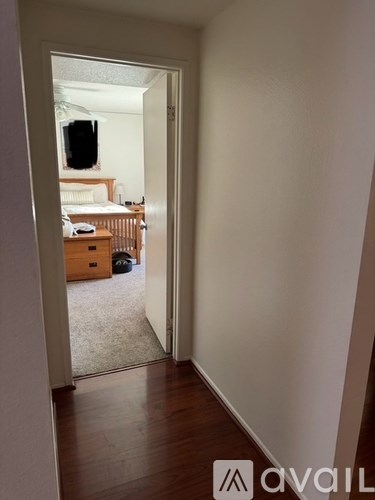 A room with a bed and a television in the background.