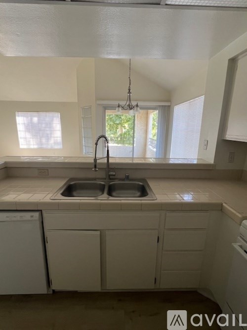 A kitchen with a sink and a window.