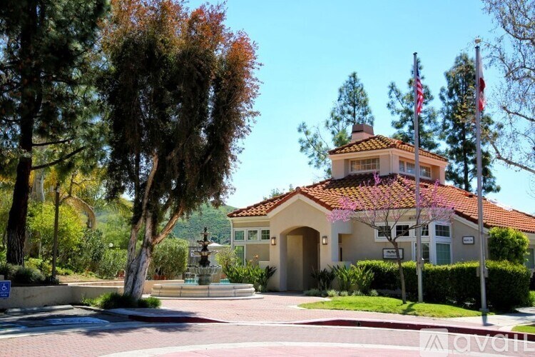 A house with a flag on the front lawn.