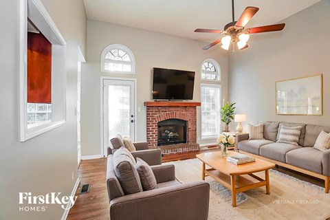 A living room with a fireplace and a television.