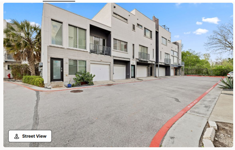 A street view of a residential area with modern buildings.