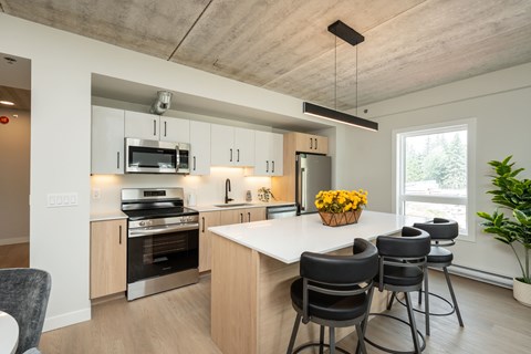 A modern kitchen with a large island and bar stools.