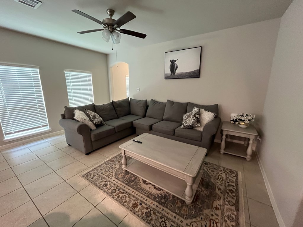 A living room with a grey couch and a coffee table.
