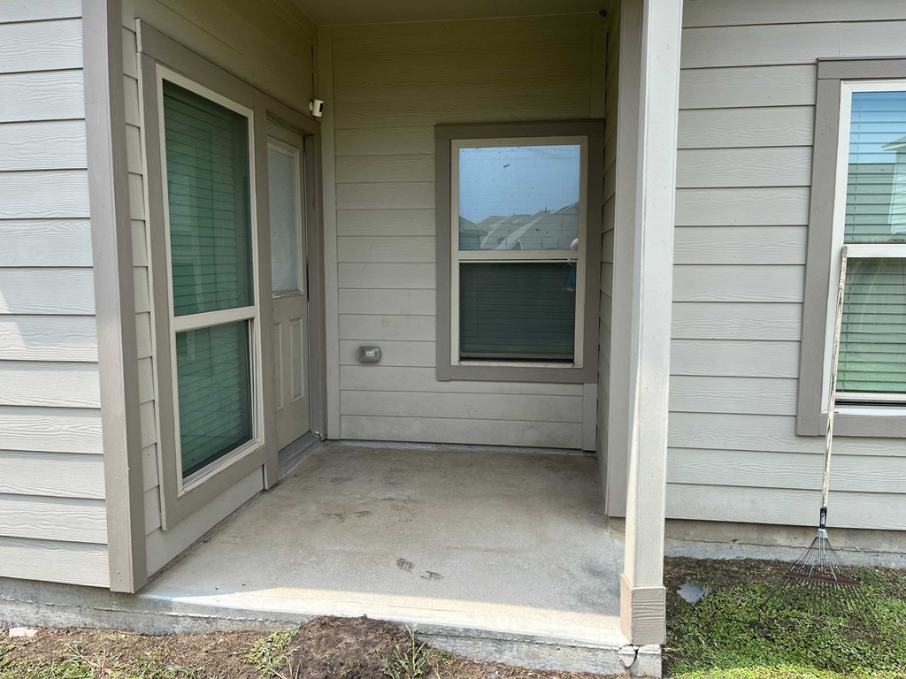 A house with a grey siding and a white door.