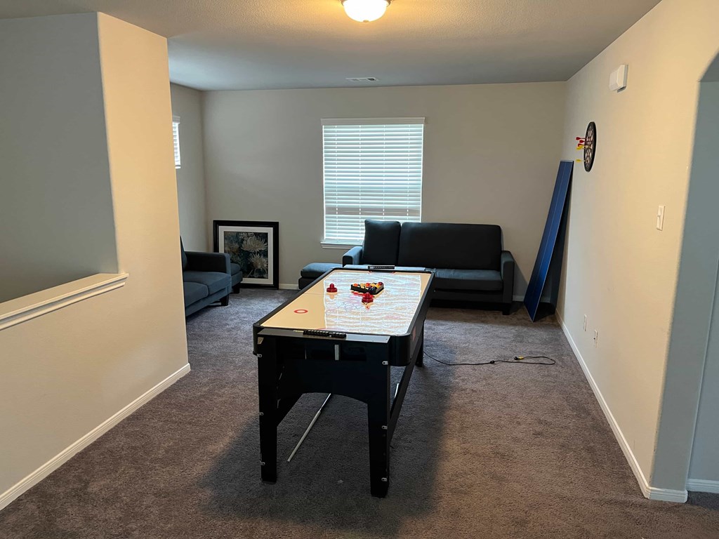 A room with a table and a couch.