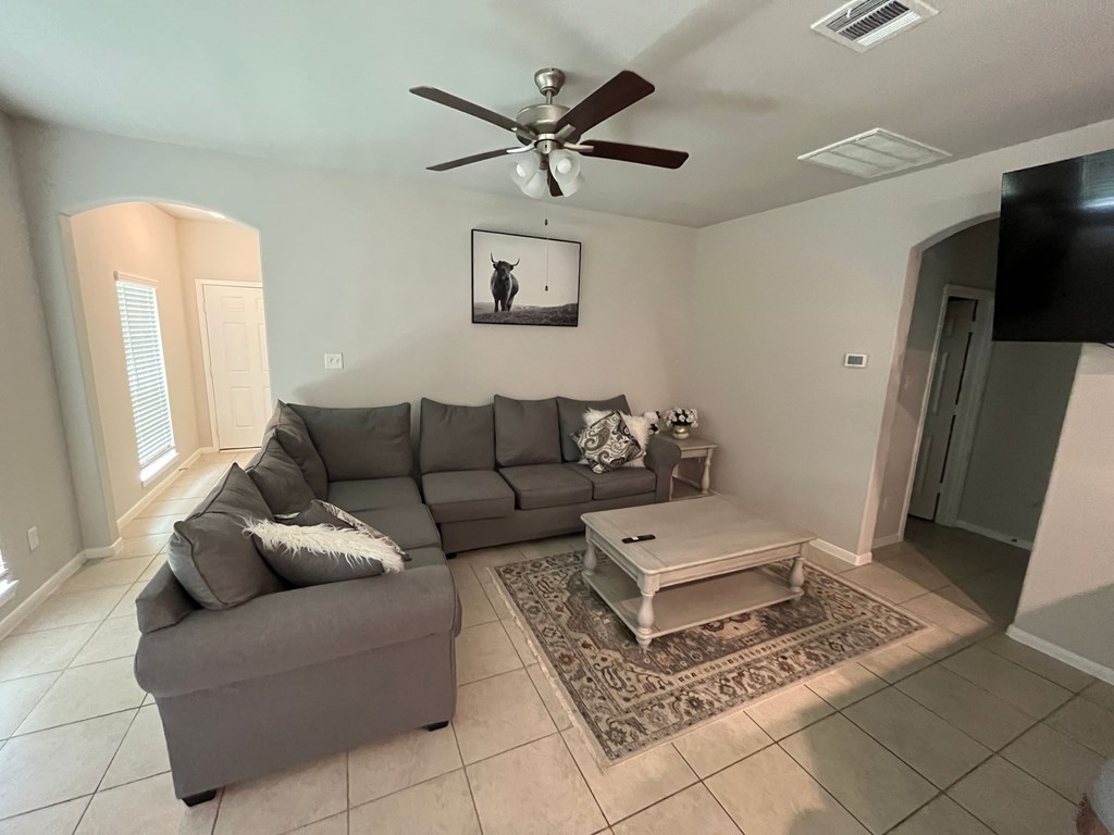 A living room with a grey couch and a coffee table.