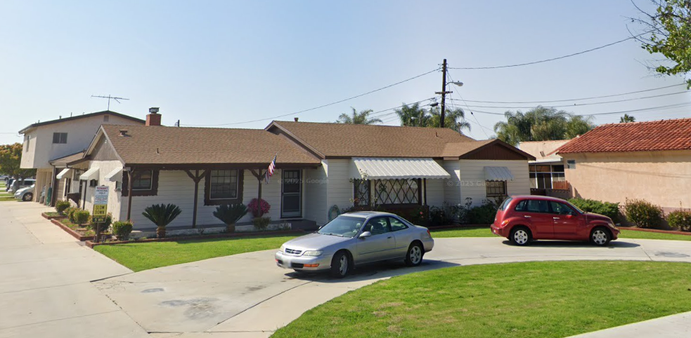 A house with a car parked in front of it.