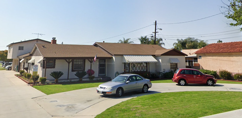 A house with a car parked in front of it.