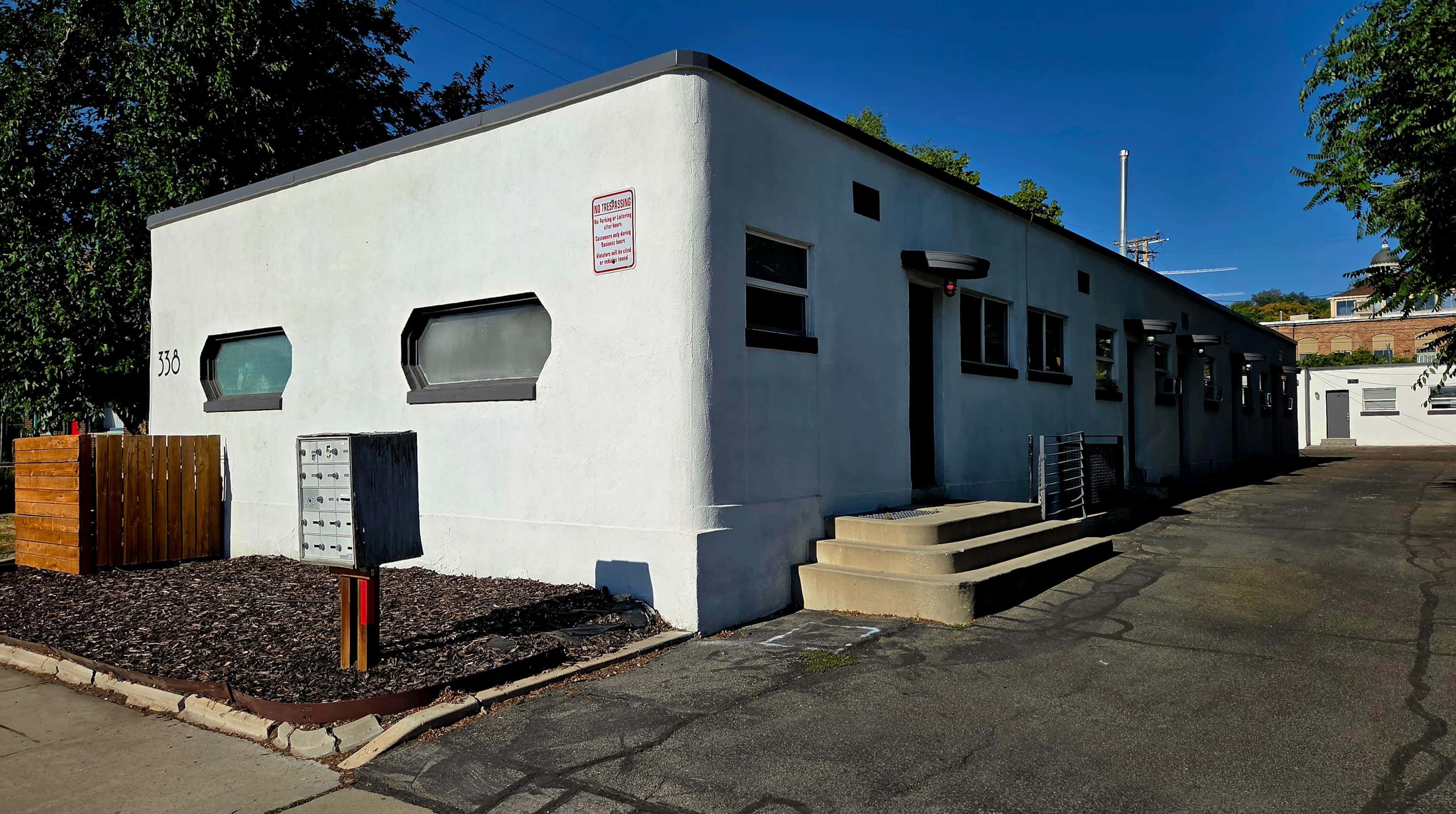 A white building with a red sign on the side.