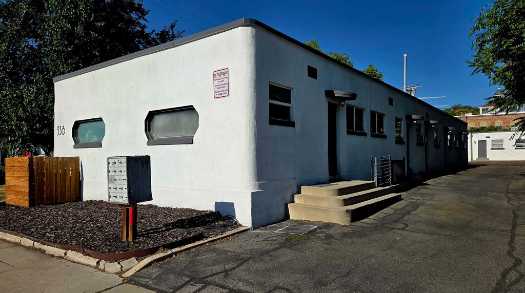 A white building with a red sign on the side.
