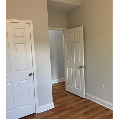 A white door is open to a hallway.