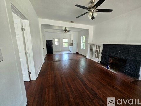 A room with a white table and chairs in front of a door.