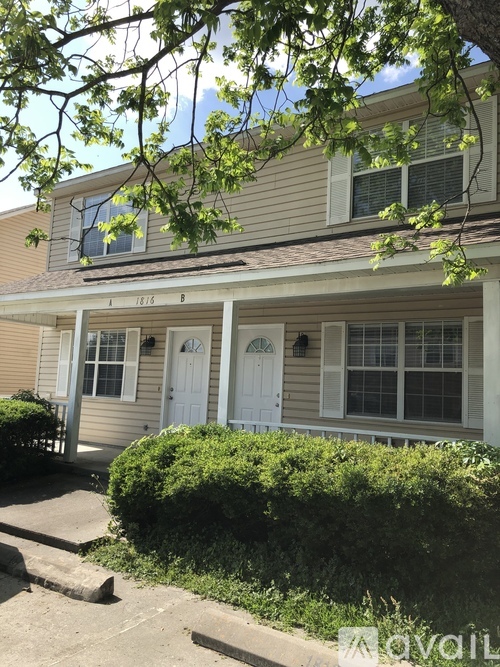 A house with a white door and windows is for sale.