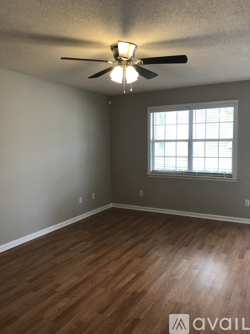 A room with a ceiling fan and a window.