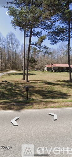 A tree stands in front of a house.