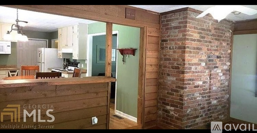 A room with a brick wall and a wooden counter with the words "Georgia MLS" on it.