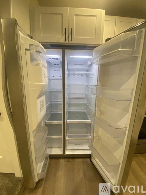 A white refrigerator with its door open and shelves visible.