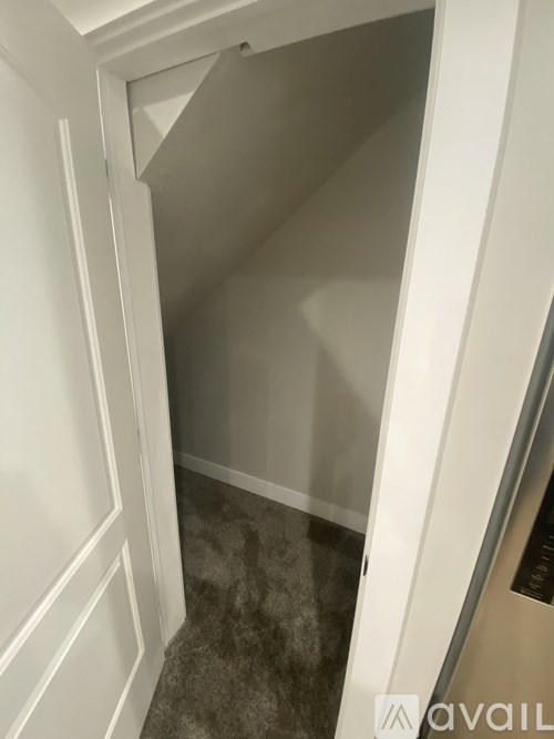 A white doorway leading to a darker room.