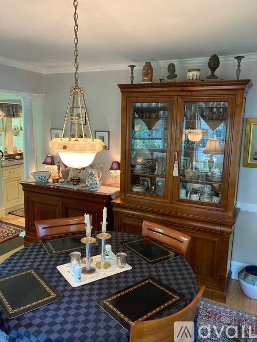 A dining room with a table set for a meal.