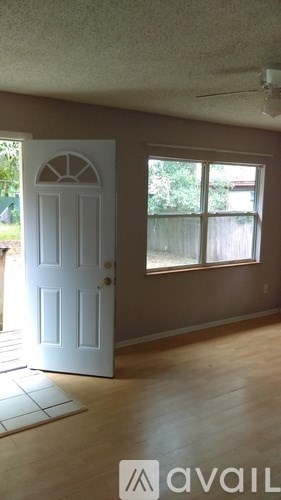 A room with a white door and a window.
