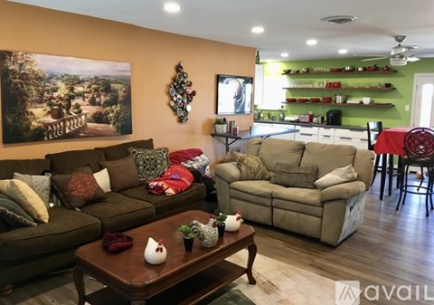 A living room with a brown couch and a coffee table in front of it.