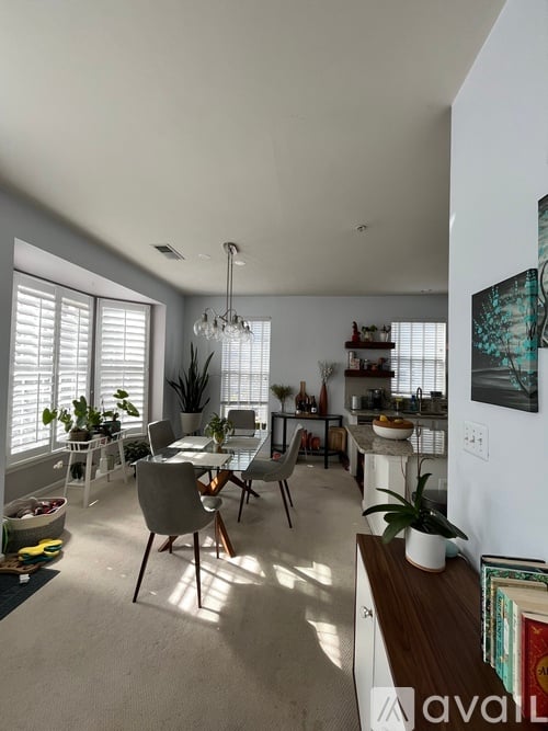 A well-lit, modern kitchen and dining area with a table set for two.
