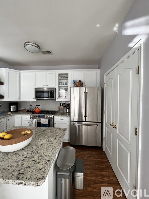 A kitchen with granite countertops and stainless steel appliances.