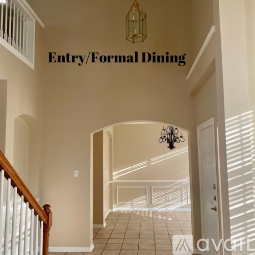 A hallway with a chandelier and a sign that says Entry/Formal Dining.
