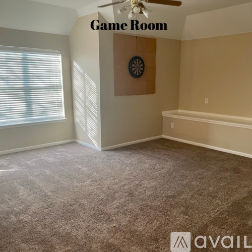 A game room with a dartboard on the wall.