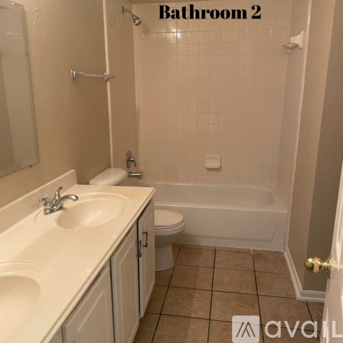 A bathroom with a toilet, sink, and bathtub.