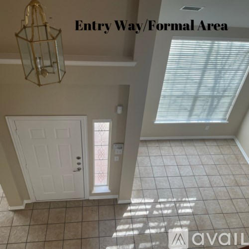 A hallway with a door and a sign on the wall.