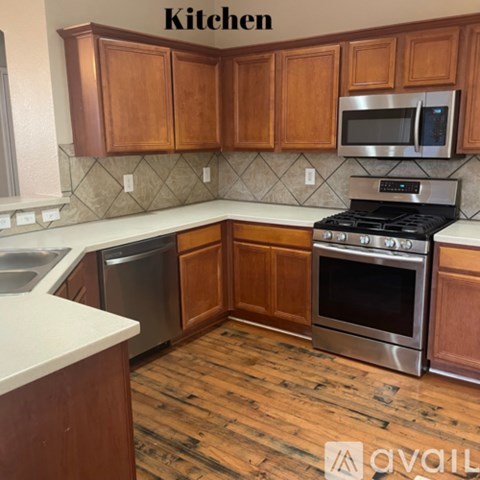 A kitchen with wooden cabinets and a stainless steel oven.