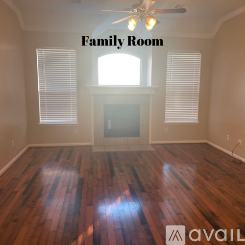 A family room with wood flooring and a fireplace.