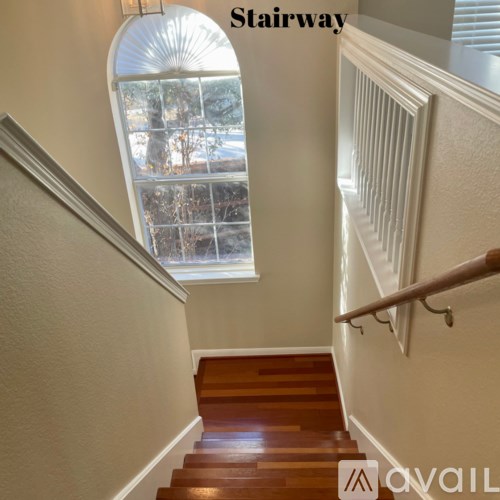 A stairway with a window above it.