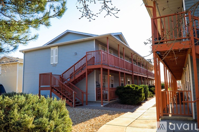 A building with a red staircase and a balcony.