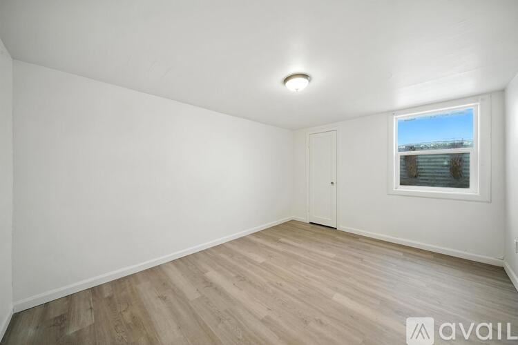 A small bathroom with a toilet and a window.