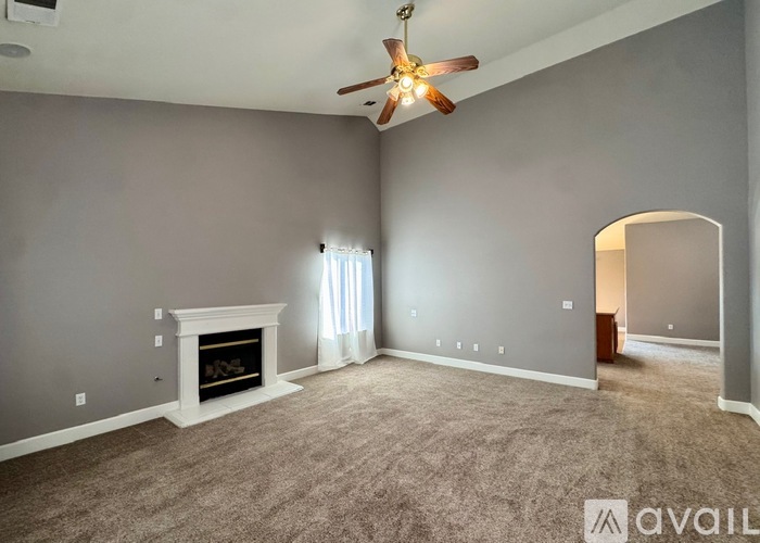 A living room with a fireplace and a window.