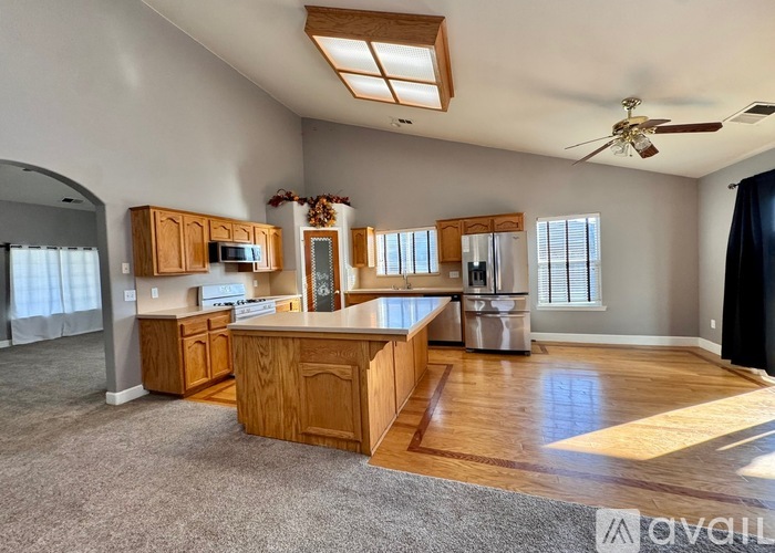 A kitchen with wooden cabinets and a white fridge.