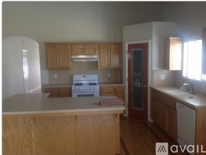 A kitchen with wooden cabinets and a white fridge.
