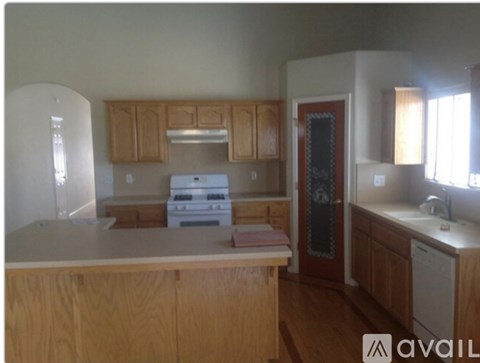 A kitchen with wooden cabinets and a white fridge.
