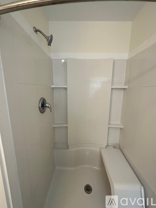 A white bathroom with a tub and a shower.