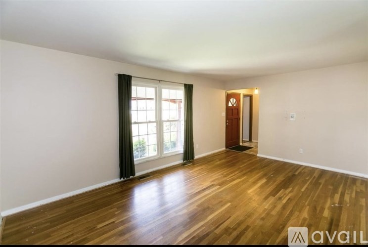 A room with wooden floors and a sliding glass door.