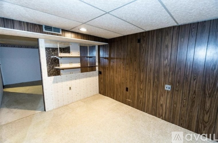 A room with wooden walls and a white ceiling.
